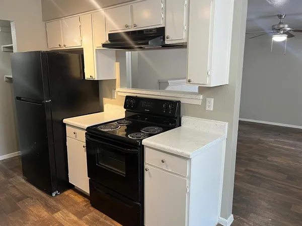 a kitchen with a stove and a refrigerator