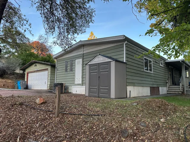 a front view of house with a garden