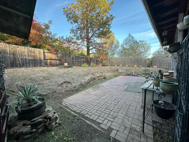 a backyard of a house with table and chairs