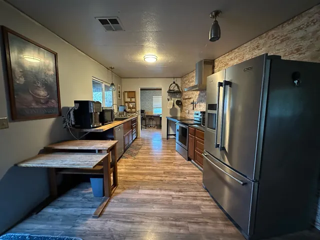 a kitchen with stainless steel appliances a refrigerator and a stove