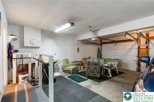 a living room with furniture a flat screen tv and a window