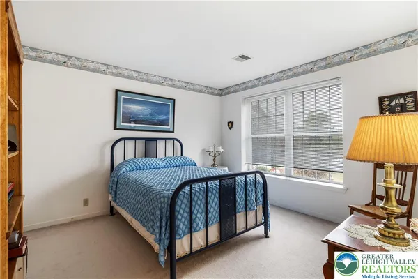 a bedroom with furniture and a window
