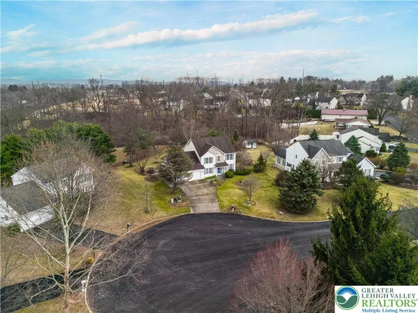 an aerial view of a house with a yard swimming pool and outdoor seating