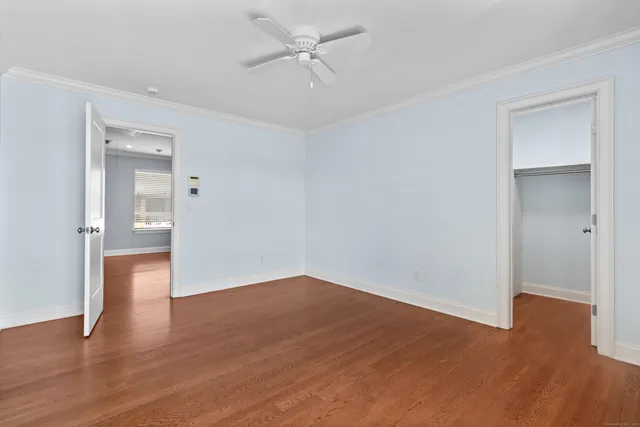 a view of an empty room with wooden floor