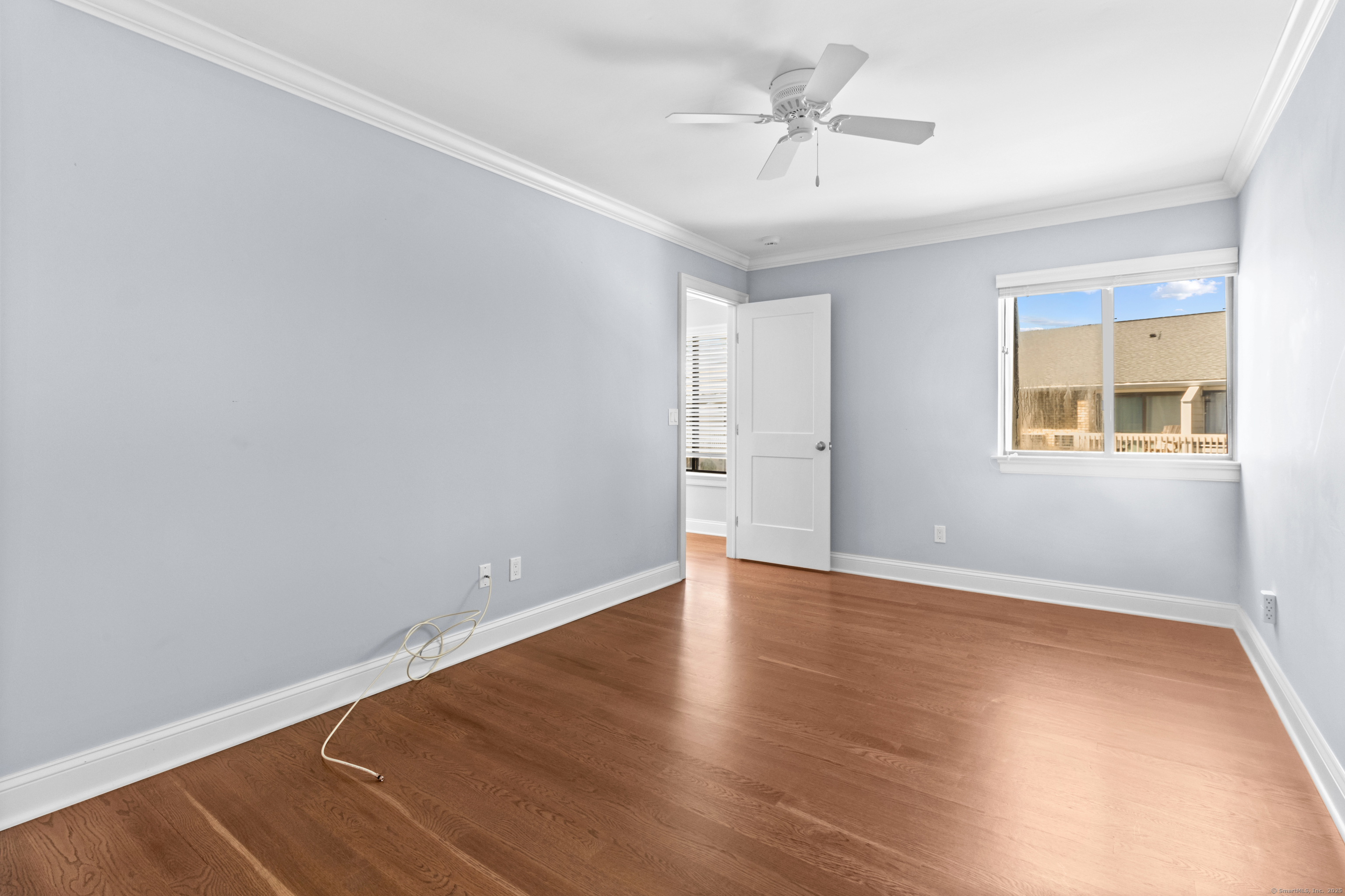 199 Gregory Boulevard, Unit D2 Norwalk, CT 06855 - Photo 22 of 31 an empty room with wooden floor and windows