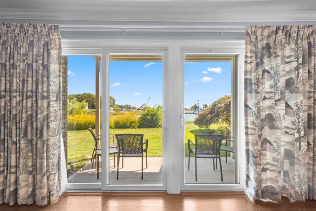 a view of a living room and floor to ceiling window