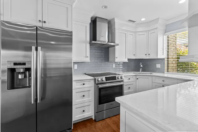 a kitchen with cabinets appliances and a window