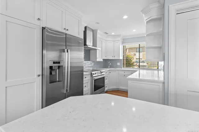 a kitchen with stainless steel appliances a refrigerator sink and cabinets