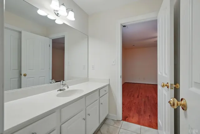 a bathroom with a sink vanity granite and a mirror