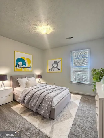 a bedroom with a bed and a painting on the wall