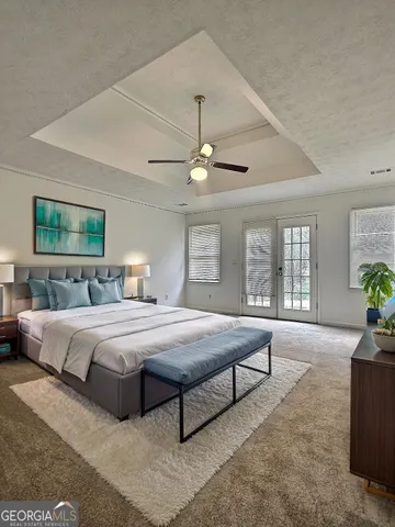 a spacious bedroom with a large bed and windows
