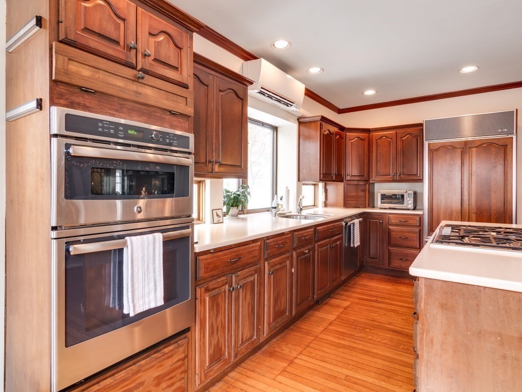 7 Emily Lane Gloucester, MA 01930 - Photo 14 of 41 a kitchen with stainless steel appliances kitchen island granite countertop a stove a sink and a refrigerator