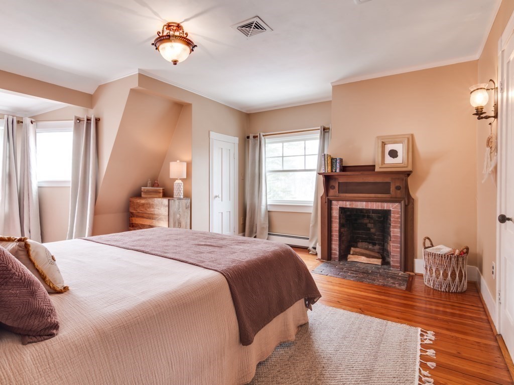 7 Emily Lane Gloucester, MA 01930 - Photo 36 of 41 a spacious bedroom with a bed and a fireplace