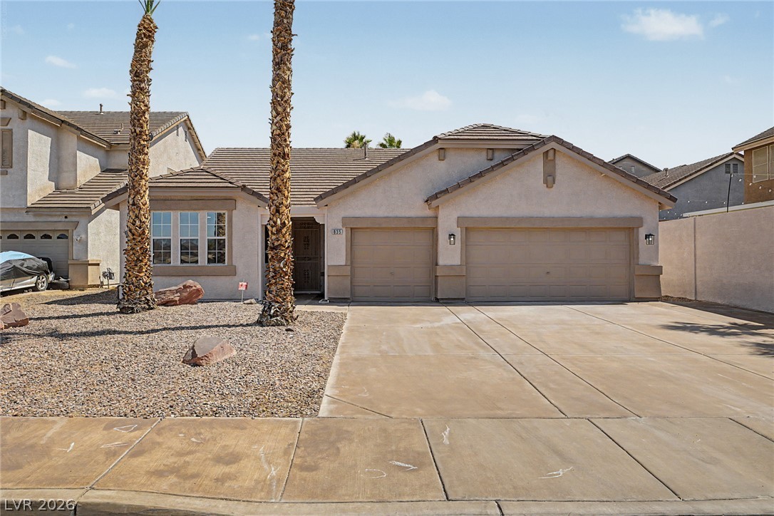 835 Entrada Ridge Avenue Henderson, NV 89012 - Photo 1 of 34 A desert-friendly facade presents with twin garage doors and a xeriscaped front yard.