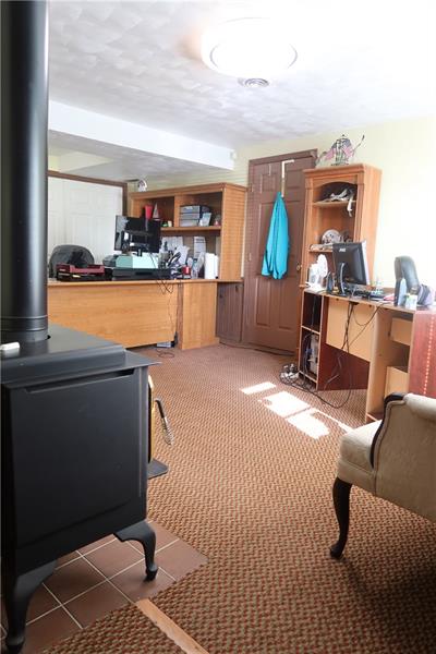 341 Story Road Export, PA 15632 - Photo 15 of 25 Lower/Main Level Gameroom/Office with WB Stove/FP off attached Garage and near exterior side foyer door