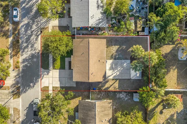 an aerial view of a house with a yard