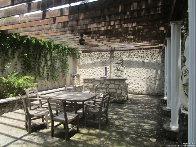 a view of a patio with table and chairs and potted plants