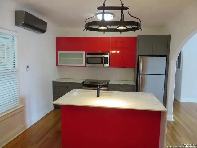 a room with table chairs and wooden floor