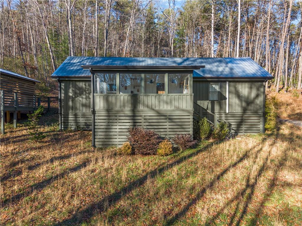 a view of house with a yard and sitting area