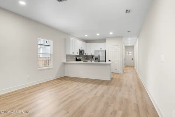 a view of kitchen and kitchen with wooden floor