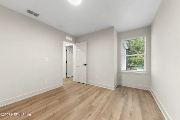 a view of room with window and hardwood floor