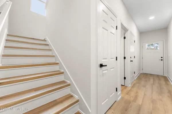 a view of a hallway with wooden floor and entryway