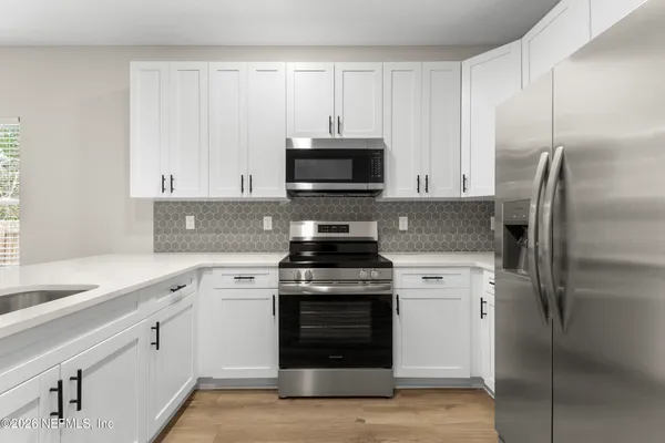 a kitchen with a stove and a refrigerator