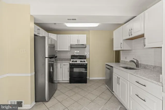 a kitchen with a sink stove and refrigerator