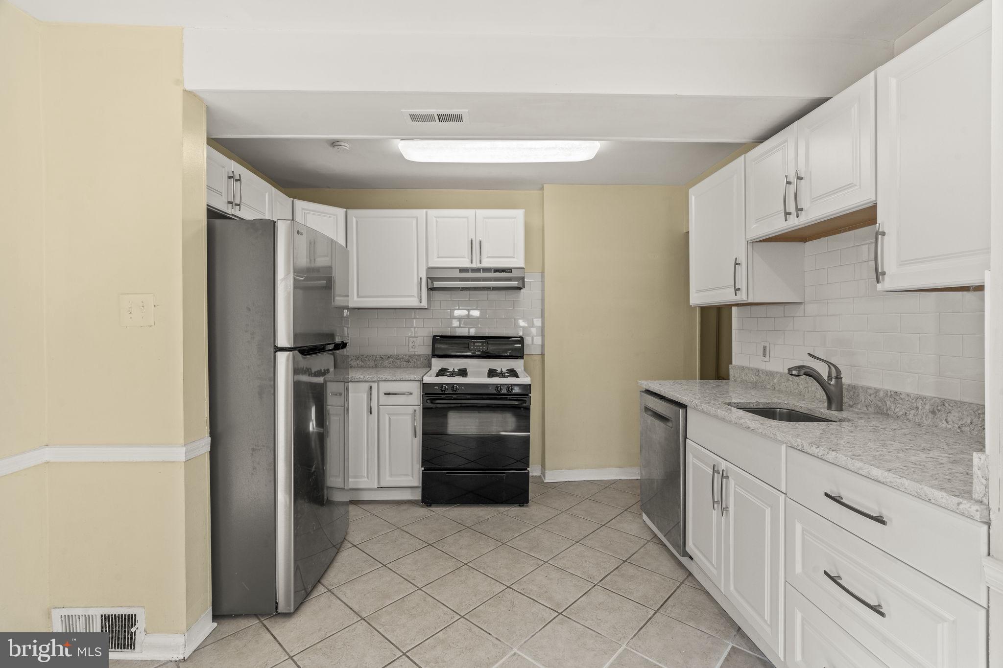 326 East Rambo Street Bridgeport, PA 19405 - Photo 6 of 23 a kitchen with a sink stove and refrigerator
