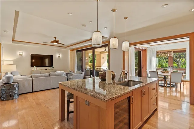 a view of living room with granite countertop furniture and a flat screen tv