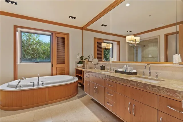 a spacious bathroom with sink mirror and bathtub