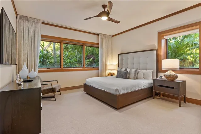 a spacious bedroom with a bed and large windows