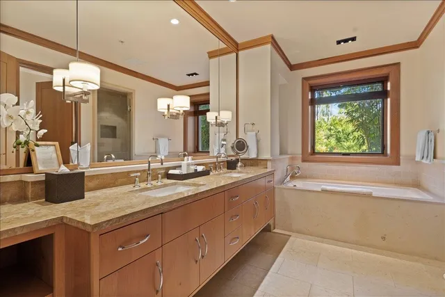a spacious bathroom with a granite countertop sink mirror and a bathtub