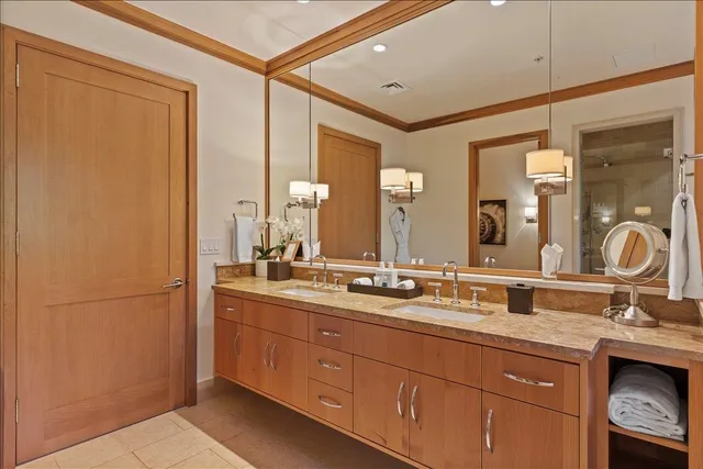a bathroom with a double vanity sink and a mirror