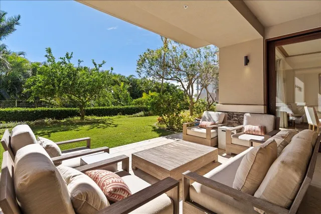 a view of a patio with swimming pool and a yard