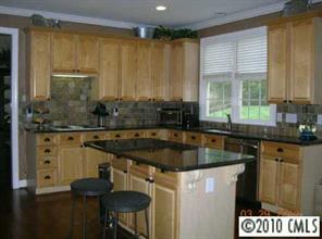 3421 Rhett Butler Place Charlotte, NC 28270 - Photo 5 of 8 a kitchen with granite countertop a sink and a window