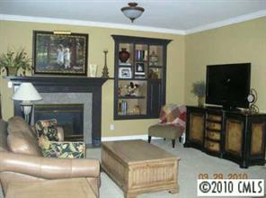 3421 Rhett Butler Place Charlotte, NC 28270 - Photo 6 of 8 a living room with furniture and a fireplace