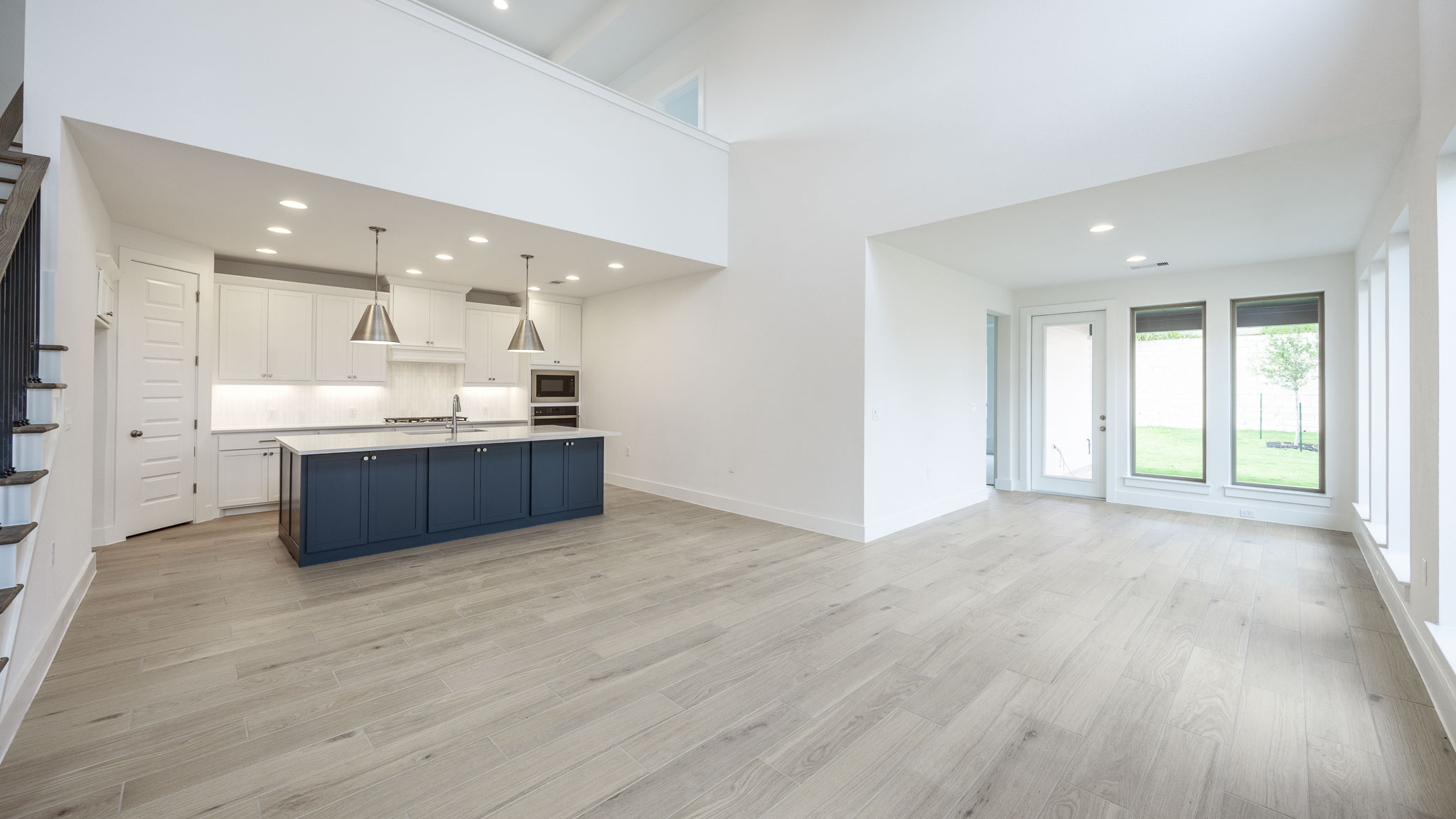 7002 Woodford Way Austin, TX 78744 - Photo 6 of 22 a room with kitchen island granite countertop a sink and a large window