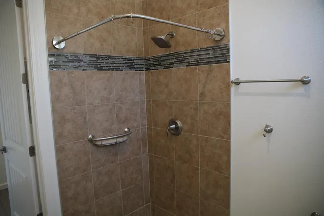 a bathroom with a granite countertop toilet a sink and a mirror