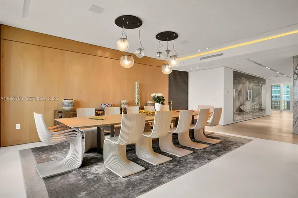 a large dining room with a table and chairs
