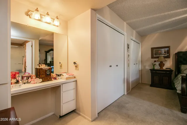 a bathroom with a granite countertop sink toilet and a mirror
