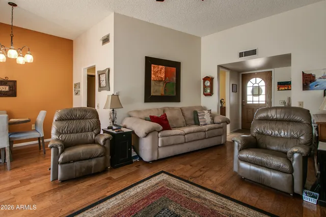 a living room with furniture fireplace and flat screen tv