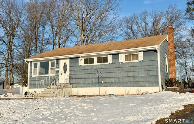 a house that has a tree in front of it
