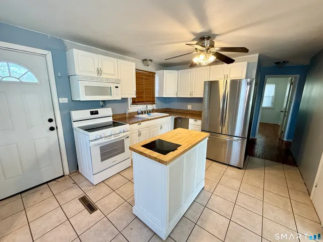 a kitchen with a stove a refrigerator and a refrigerator