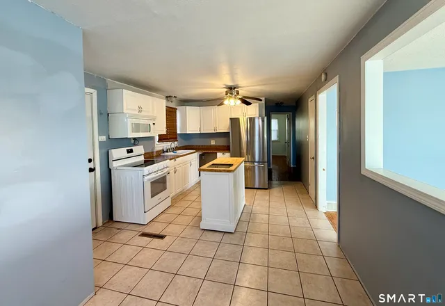 a kitchen with a stove a sink and a refrigerator
