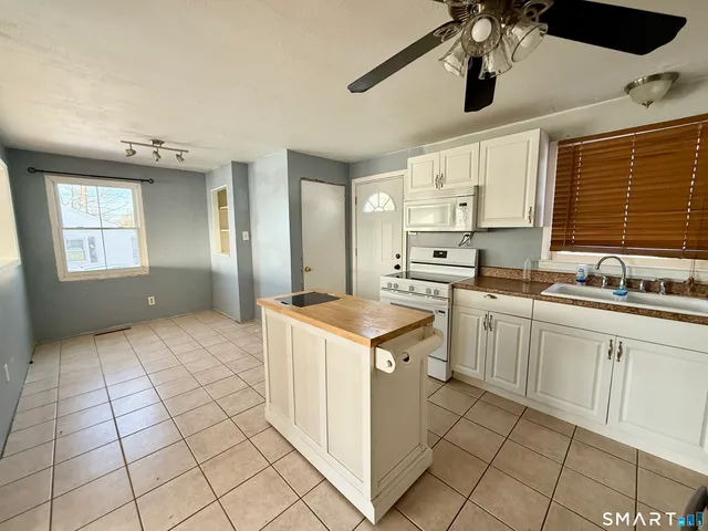a kitchen with a stove a sink and a refrigerator