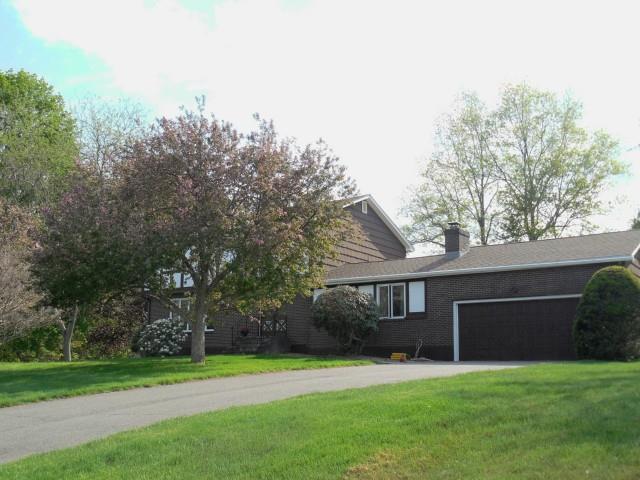 23 High Meadow Road Shelton, CT 06484 - Photo 1 of 1 a front view of a house with a yard and trees