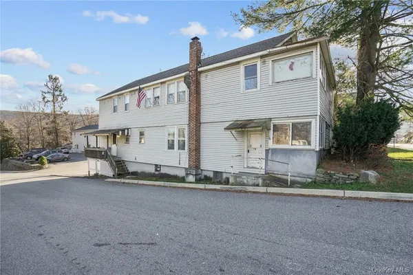 a view of a house with a yard and garage