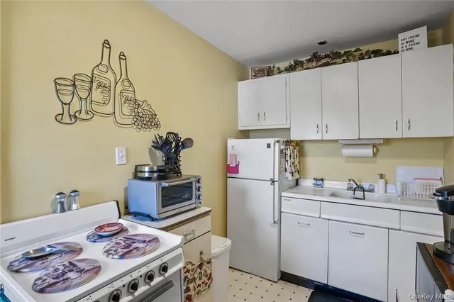 a kitchen with a refrigerator and a stove top oven