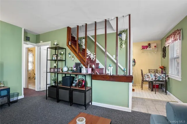 a living room with furniture and a painting on the wall